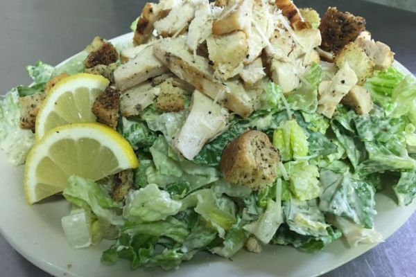 house Ceasar Salad with parmesan crisp and cheese